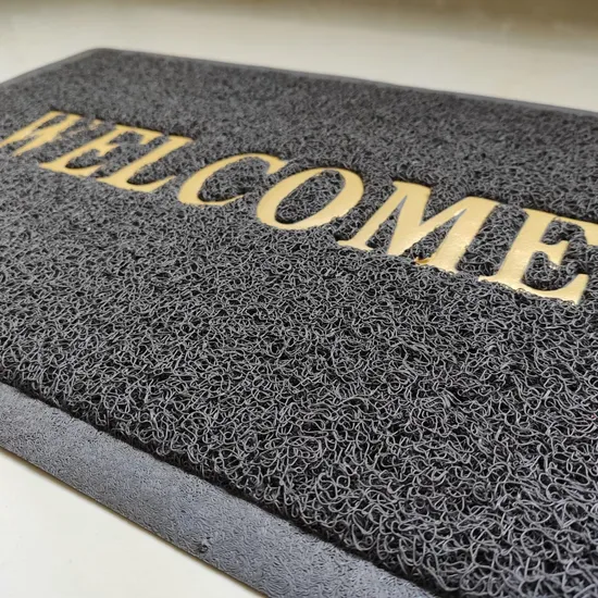 Felpudo de vinilo PVC con diseño de espiral para exteriores, ideal como felpudo decorativo.